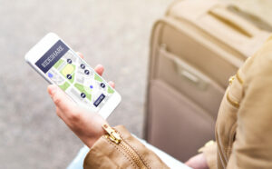 Woman holding her phone using a ridesharing app